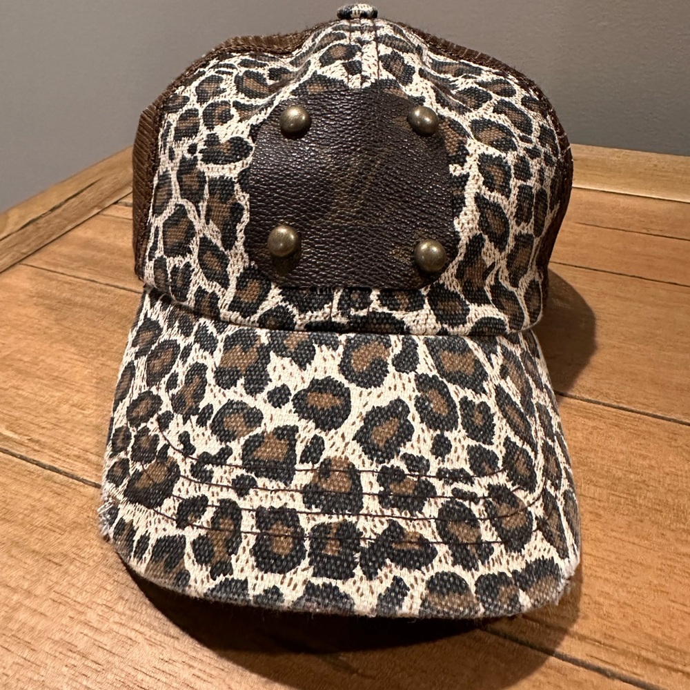 Women’s leopard print trucker hat featuring a Louis Vuitton–style patch